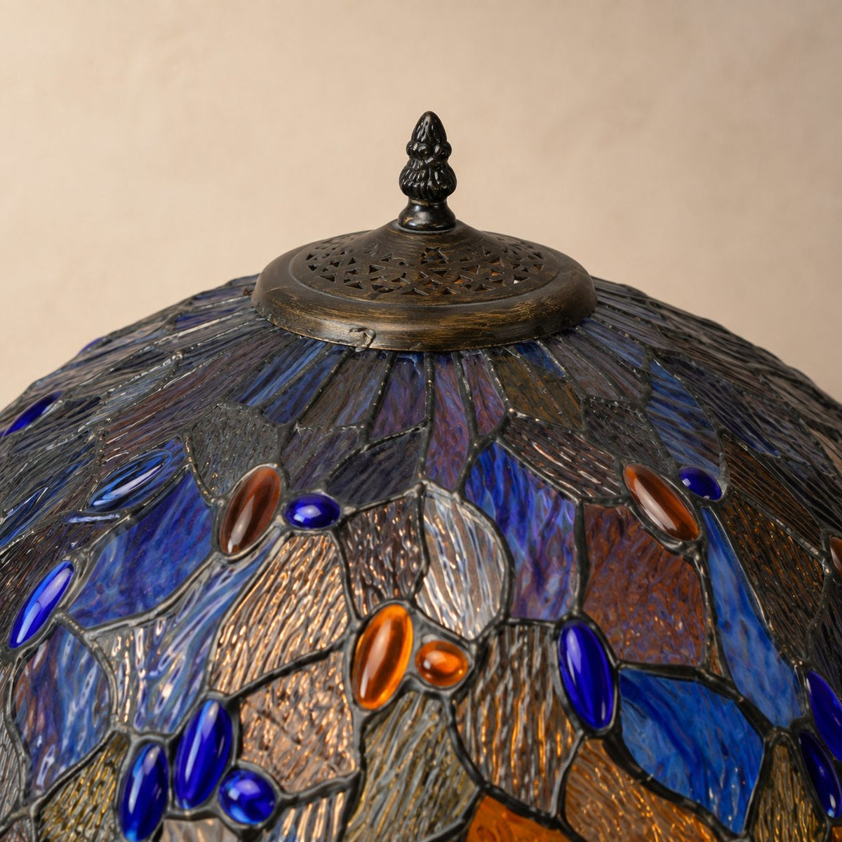 Lampe de style Tiffany à décor de feuillages bleus et ambrés, détail fleuron cache ampoule