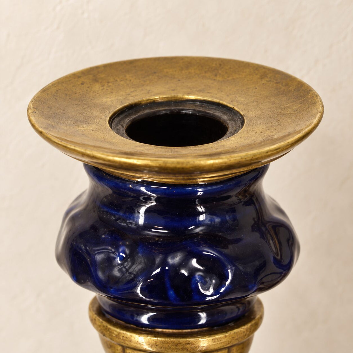 Applique murale au putto en bronze doré et porcelaine bleue, détail bras bougeoir latéral gros plan