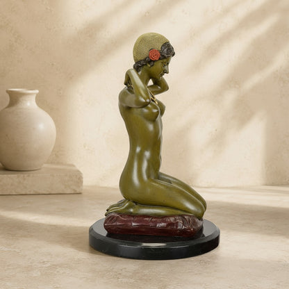 Sculpture en bronze représentant une femme agenouillée sur un coussin bordeaux avec un socle en marbre
