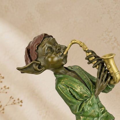 Sculpture en bronze polychrome représentant un lutin jouant du saxophone avec tunique verte