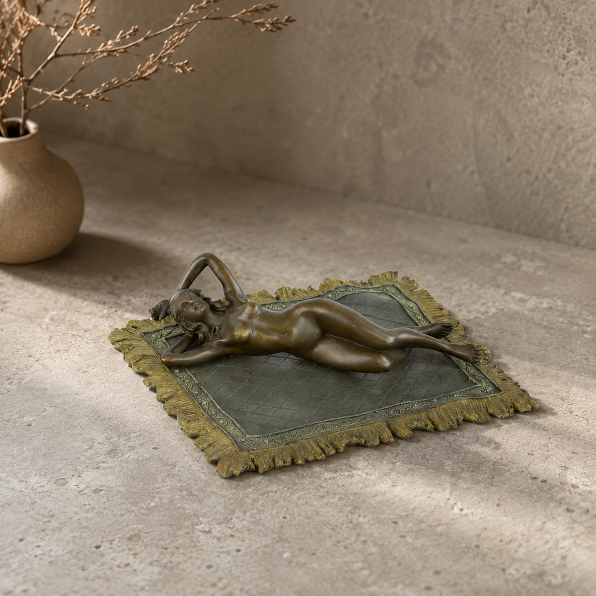 Sculpture bronze nu féminin allongé sur tapis à franges