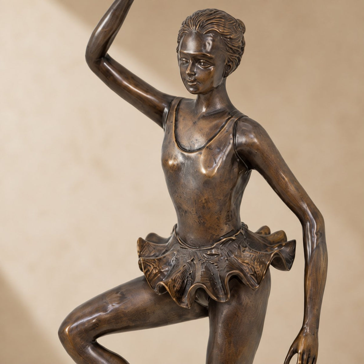 Sculpture en bronze ballerine en position de passé, vue rapprochée buste bras levé